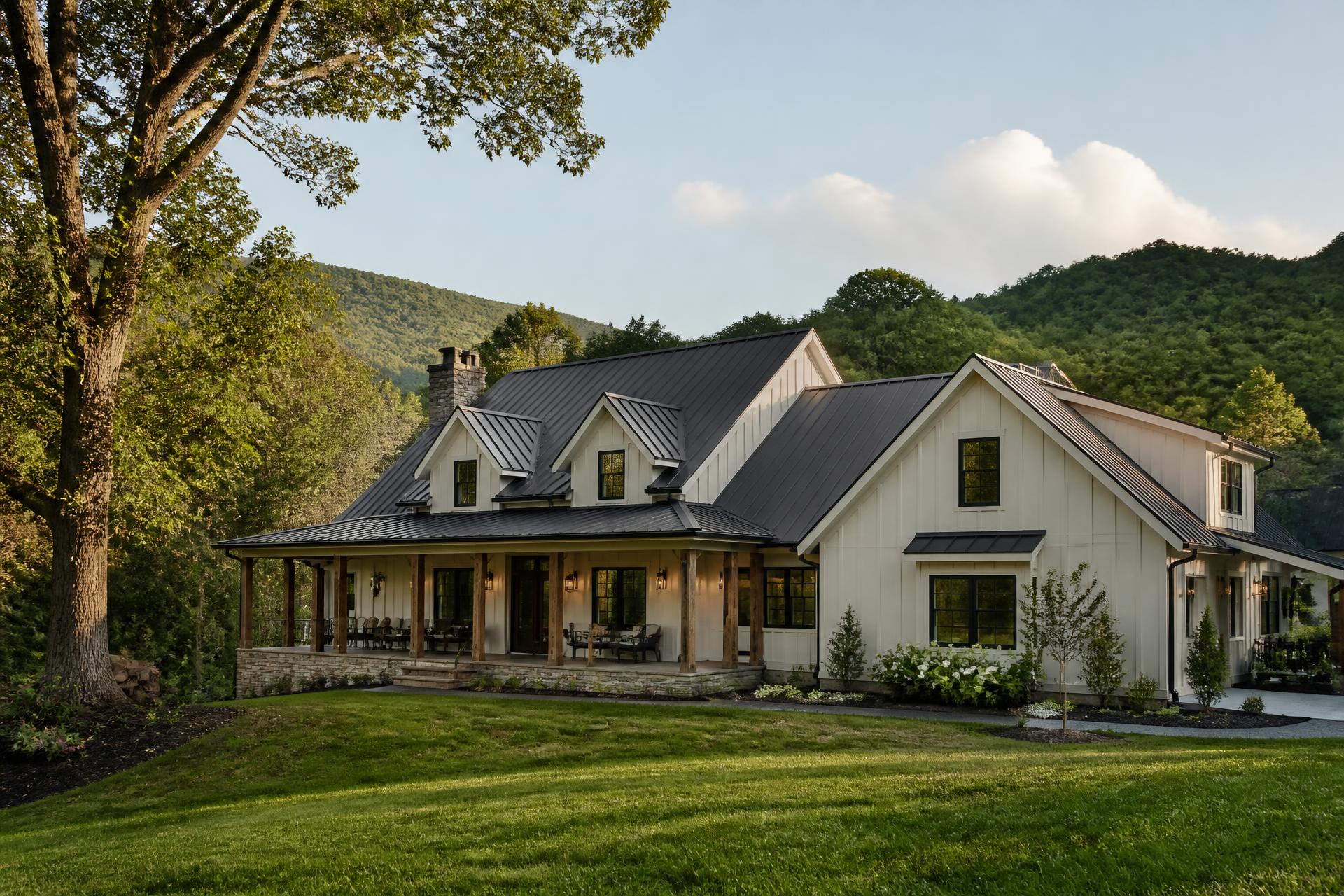 Modern farmhouse home with dark metal roof and full-length covered porch in the East Tennessee foothills